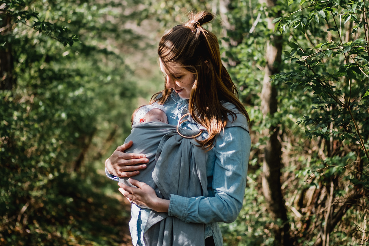 A mother carrying her child in a sling
