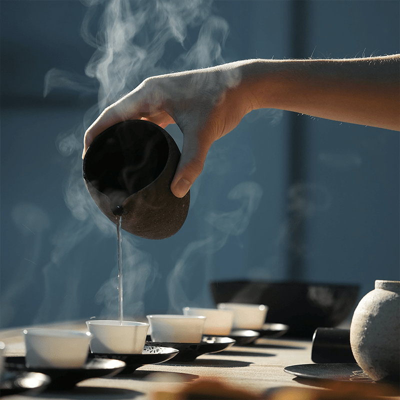 A calm image showing tea being poured into cups